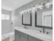 Modern bathroom featuring double vanity, updated lighting, and a tiled shower at 6593 Meritmoor Cir, Orlando, FL 32818