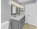 Bathroom featuring a double sink vanity with modern fixtures and a framed mirror at 6593 Meritmoor Cir, Orlando, FL 32818