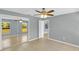 Bright bedroom features tile flooring, a ceiling fan, mirror closet doors, and a door to another room at 6593 Meritmoor Cir, Orlando, FL 32818