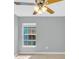 Bedroom with tile floors, ceiling fan, and a window with exterior view at 6593 Meritmoor Cir, Orlando, FL 32818