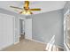 Bright bedroom featuring tile flooring, a ceiling fan, and an ensuite bathroom at 6593 Meritmoor Cir, Orlando, FL 32818
