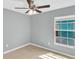 Bedroom with tile floors, a ceiling fan, and a window with exterior view at 6593 Meritmoor Cir, Orlando, FL 32818