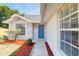 Home featuring a bright blue front door and well maintained landscape at 6593 Meritmoor Cir, Orlando, FL 32818