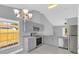 Stylish kitchen with gray cabinetry, stone countertops, stainless steel appliances, and a chandelier at 6593 Meritmoor Cir, Orlando, FL 32818
