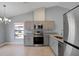 Modern kitchen with gray cabinetry, stainless steel appliances, and granite countertops at 6593 Meritmoor Cir, Orlando, FL 32818