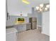 Bright, modern kitchen features gray cabinetry, stainless appliances and stone countertops at 6593 Meritmoor Cir, Orlando, FL 32818