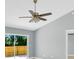 Living room featuring tile flooring, a ceiling fan, and sliding glass doors to the outdoor space at 6593 Meritmoor Cir, Orlando, FL 32818