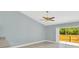 Bright living room featuring tile flooring, a ceiling fan, and sliding glass doors to the outdoor space at 6593 Meritmoor Cir, Orlando, FL 32818