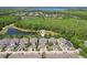 Aerial view of neighborhood homes with lush green space and a pond at 6632 Pasturelands Pl, Winter Garden, FL 34787
