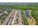 An aerial view of homes alongside a scenic pond and lush trees in a well-planned neighborhood at 6632 Pasturelands Pl, Winter Garden, FL 34787