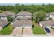 An aerial view showcasing the house, garage, and lush green surroundings at 6632 Pasturelands Pl, Winter Garden, FL 34787