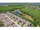 Aerial view of a lovely community bordered by lush forests and scenic pond, featuring charming homes at 6632 Pasturelands Pl, Winter Garden, FL 34787