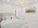 Well-lit bedroom featuring a comfortable bed, stylish decor, and a serene atmosphere at 6632 Pasturelands Pl, Winter Garden, FL 34787