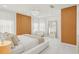 Bright bedroom with wood accents, chandelier lighting, and a large mirror at 6632 Pasturelands Pl, Winter Garden, FL 34787