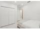 Bright bedroom with closet doors, a comfy bed, and neutral decor, perfect for relaxation at 6632 Pasturelands Pl, Winter Garden, FL 34787