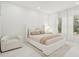 Cozy bedroom featuring a comfortable bed, chair, and soft, natural lighting at 6632 Pasturelands Pl, Winter Garden, FL 34787