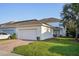Charming home exterior featuring a two-car garage and well-maintained lawn at 6632 Pasturelands Pl, Winter Garden, FL 34787