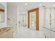 Bright Foyer featuring white tile flooring, wood accent wall, and plenty of natural light at 6632 Pasturelands Pl, Winter Garden, FL 34787