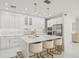 Modern kitchen with white cabinetry, sleek appliances, an island with bar seating and ample natural light at 6632 Pasturelands Pl, Winter Garden, FL 34787