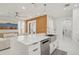 This kitchen features stainless appliances, quartz countertops, island sink, and modern fixtures at 6632 Pasturelands Pl, Winter Garden, FL 34787