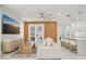Bright living room with a modern ceiling fan and seamlessly connected to the open kitchen at 6632 Pasturelands Pl, Winter Garden, FL 34787