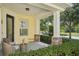 Charming covered front porch with stone pillar accents and seating area at 6632 Pasturelands Pl, Winter Garden, FL 34787
