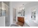 Bright bathroom with large tub, walk-in shower, and vanity with ample storage and mirrors at 6714 Bouganvillea Crescent Dr, Orlando, FL 32809