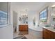 Well-lit bathroom featuring a soaking tub, walk-in shower, and double vanity sinks for convenience at 6714 Bouganvillea Crescent Dr, Orlando, FL 32809