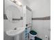 Cozy powder room featuring a pedestal sink, toilet, and charming paisley wallpaper border at 6714 Bouganvillea Crescent Dr, Orlando, FL 32809