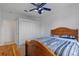 Well-lit bedroom with ceiling fan, closet, and doorway at 6714 Bouganvillea Crescent Dr, Orlando, FL 32809