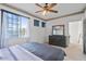Comfortable bedroom with a large window, ceiling fan, carpet, and a stylish dresser at 6714 Bouganvillea Crescent Dr, Orlando, FL 32809