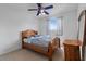 Bright bedroom features a ceiling fan, a window with curtains and simple furnishings at 6714 Bouganvillea Crescent Dr, Orlando, FL 32809