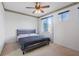 Neutral bedroom with a comfortable gray bed and cozy ambiance, illuminated by natural light at 6714 Bouganvillea Crescent Dr, Orlando, FL 32809