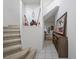 Bright entryway with tiled floors, staircase, and a decorative display niche, leading into the living spaces at 6714 Bouganvillea Crescent Dr, Orlando, FL 32809