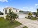 Elegant home showcasing a three-car garage, expansive driveway, and mature landscaping at 6714 Bouganvillea Crescent Dr, Orlando, FL 32809