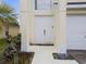 Charming home entrance featuring double doors, white columns, and a two car garage at 6714 Bouganvillea Crescent Dr, Orlando, FL 32809