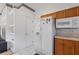 A classic kitchen with white appliances, white tile flooring, wooden cabinets, and a functional layout at 6714 Bouganvillea Crescent Dr, Orlando, FL 32809