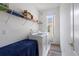 Functional laundry room featuring modern appliances, shelving, and natural light at 6714 Bouganvillea Crescent Dr, Orlando, FL 32809
