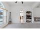 Bright and airy living room featuring arched doorways, a wet bar, and a view of the backyard pool area at 6714 Bouganvillea Crescent Dr, Orlando, FL 32809