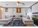 Cozy living room with large sectional sofa, decorative art, aquarium, and natural light at 6714 Bouganvillea Crescent Dr, Orlando, FL 32809