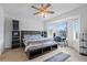 Comfortable main bedroom featuring a ceiling fan and a built-in storage bench under the bed at 6714 Bouganvillea Crescent Dr, Orlando, FL 32809