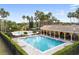 A luxurious community pool area with a splash pad, covered picnic area, and palm trees, perfect for relaxation at 6714 Bouganvillea Crescent Dr, Orlando, FL 32809