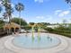 Community splashpad and pool area with a yellow-roofed structure and lounge chairs, surrounded by landscaping at 6714 Bouganvillea Crescent Dr, Orlando, FL 32809