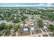 Expansive aerial view showcasing the neighborhood featuring mature trees and various home styles at 690 W Pearl St, Bartow, FL 33830