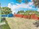 Spacious fenced backyard with lush greenery and storage shed at 690 W Pearl St, Bartow, FL 33830
