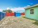 Fenced backyard featuring a storage shed and grass at 690 W Pearl St, Bartow, FL 33830