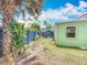 Backyard featuring mature landscaping, patio area, and fenced perimeter at 690 W Pearl St, Bartow, FL 33830