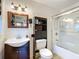 A bright bathroom featuring a vanity sink, mirrored cabinet, and a shower with glass doors at 690 W Pearl St, Bartow, FL 33830