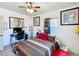 A cozy bedroom with a decorative bed, ceiling fan, and a work desk at 690 W Pearl St, Bartow, FL 33830