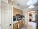 A cozy kitchen with stainless steel sink, microwave, cabinets, and tiled flooring for convenience and functionality at 690 W Pearl St, Bartow, FL 33830